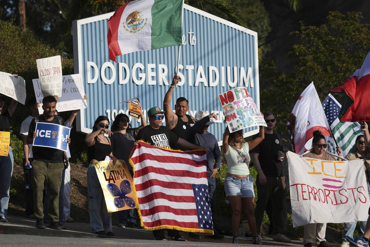 FILE - Demonstrators stage outside Dodger Stadium, June 21, 2025, in Los Angeles. (AP Photo/Dam ...