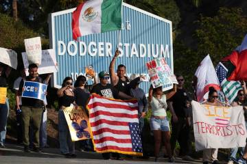 FILE - Demonstrators stage outside Dodger Stadium, June 21, 2025, in Los Angeles. (AP Photo/Dam ...
