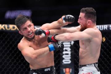 Merab Dvalishvili, right, connects with Henry Cejudo during their bantamweight bout at the UFC ...