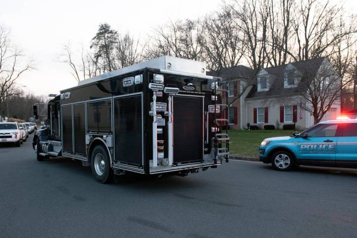 An FBI truck departs the street where the FBI made an arrest and are investigating a house in W ...