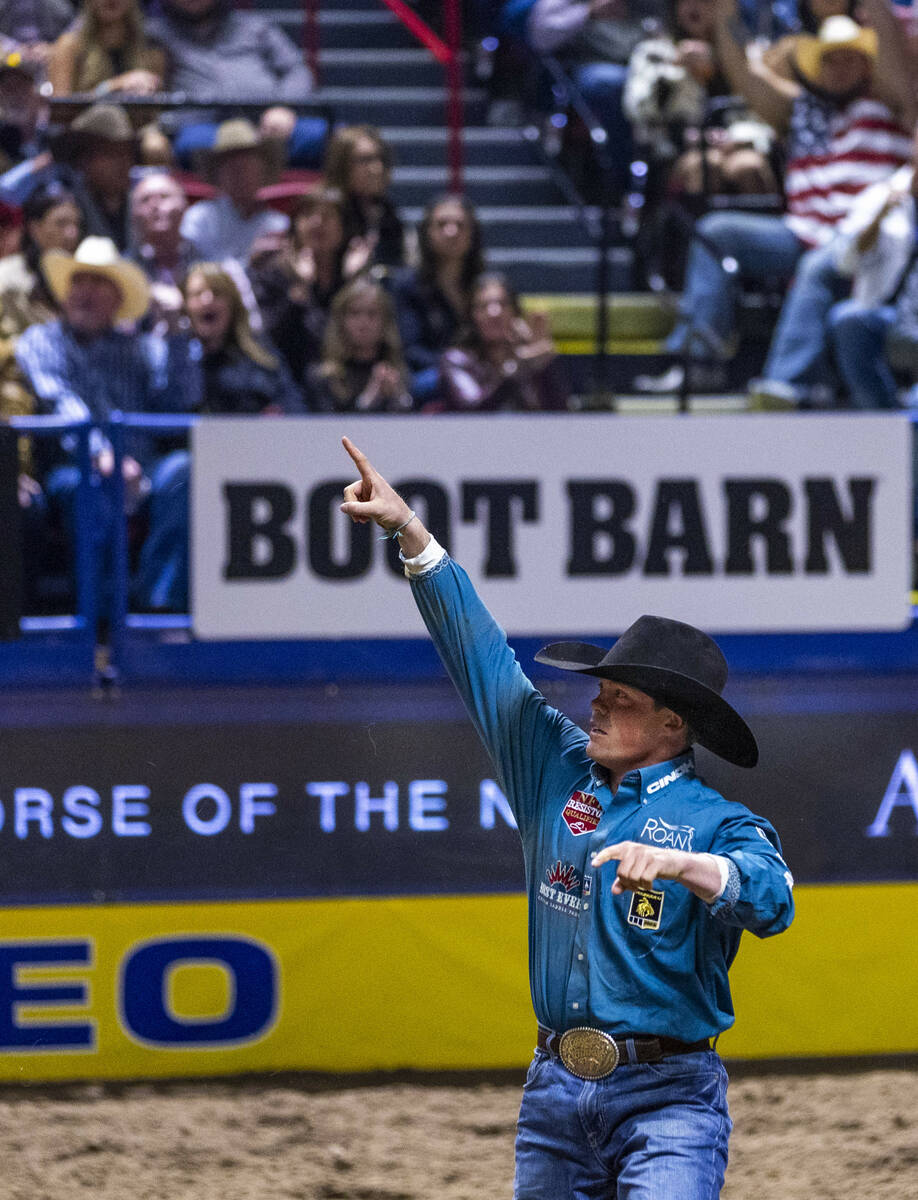 Tucker Allen celebrates a tying win in Steer Wrestling during Day 2 of National Finals Rodeo at ...