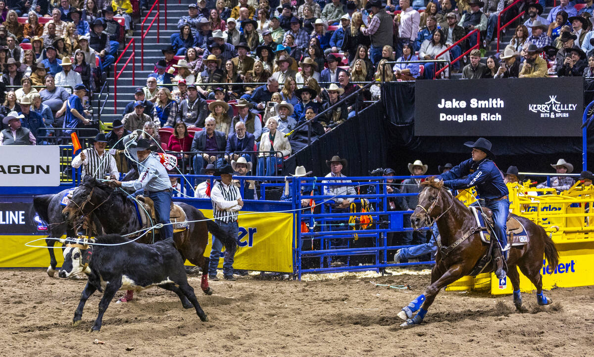 Heeler Douglas Rich, left, and header Jake Smith work to tope their calf for a win in Team Ropi ...