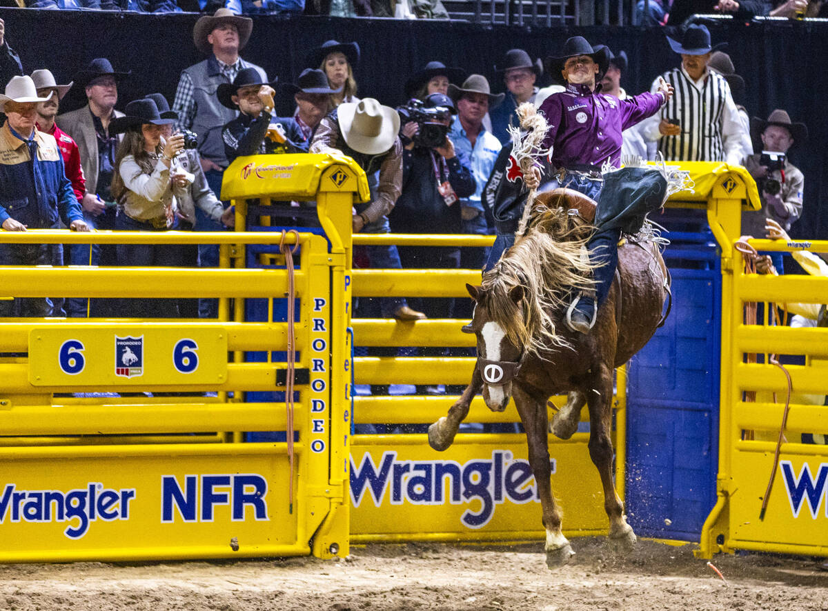 Damian Brennan rides R. Watson's Prairie Fire for a win in Saddle Bronc Riding during Day ...