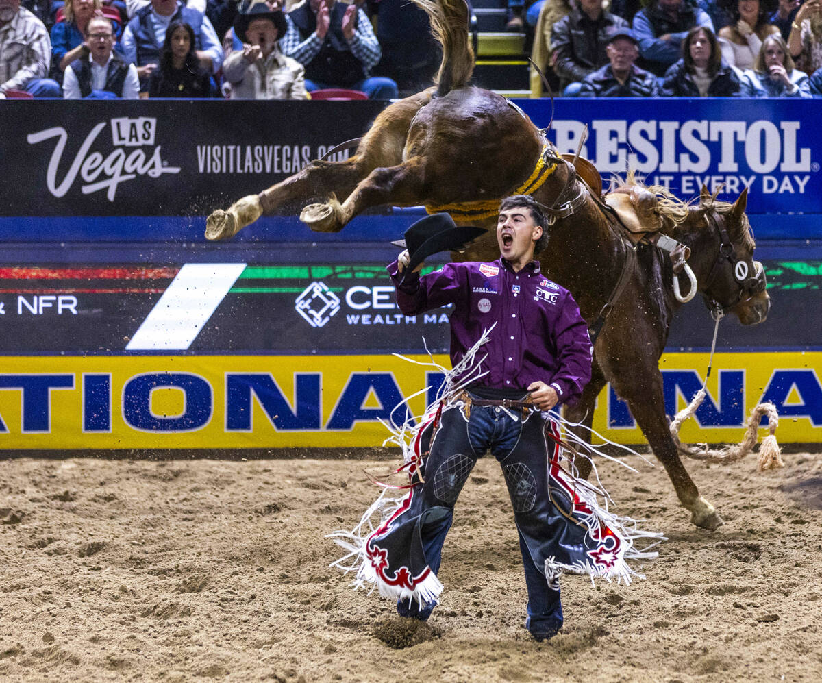 Damian Brennan celebrates a win after riding R. Watson's Prairie Fire in Saddle Bronc Ridi ...