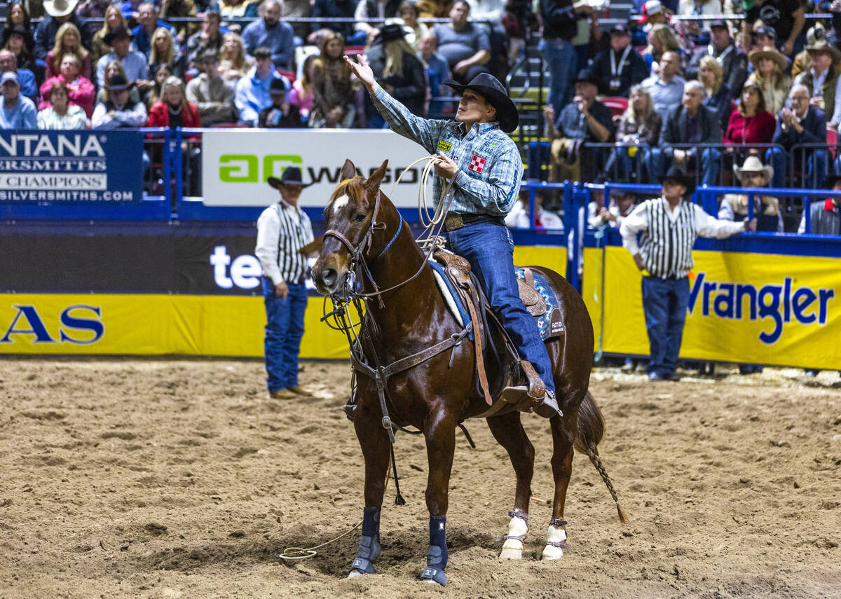 Marty Yates celebrates a tying win in Tie-Down Roping during Day 2 of National Finals Rodeo at ...