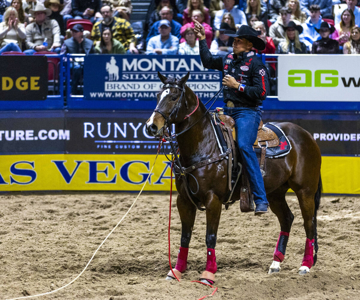 Shad Mayfield celebrates a tying win in Tie-Down Roping during Day 2 of National Finals Rodeo a ...