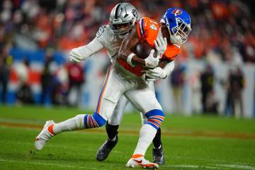 Las Vegas Raiders defensive end Charles Snowden (49) tackles Denver Broncos wide receiver Court ...