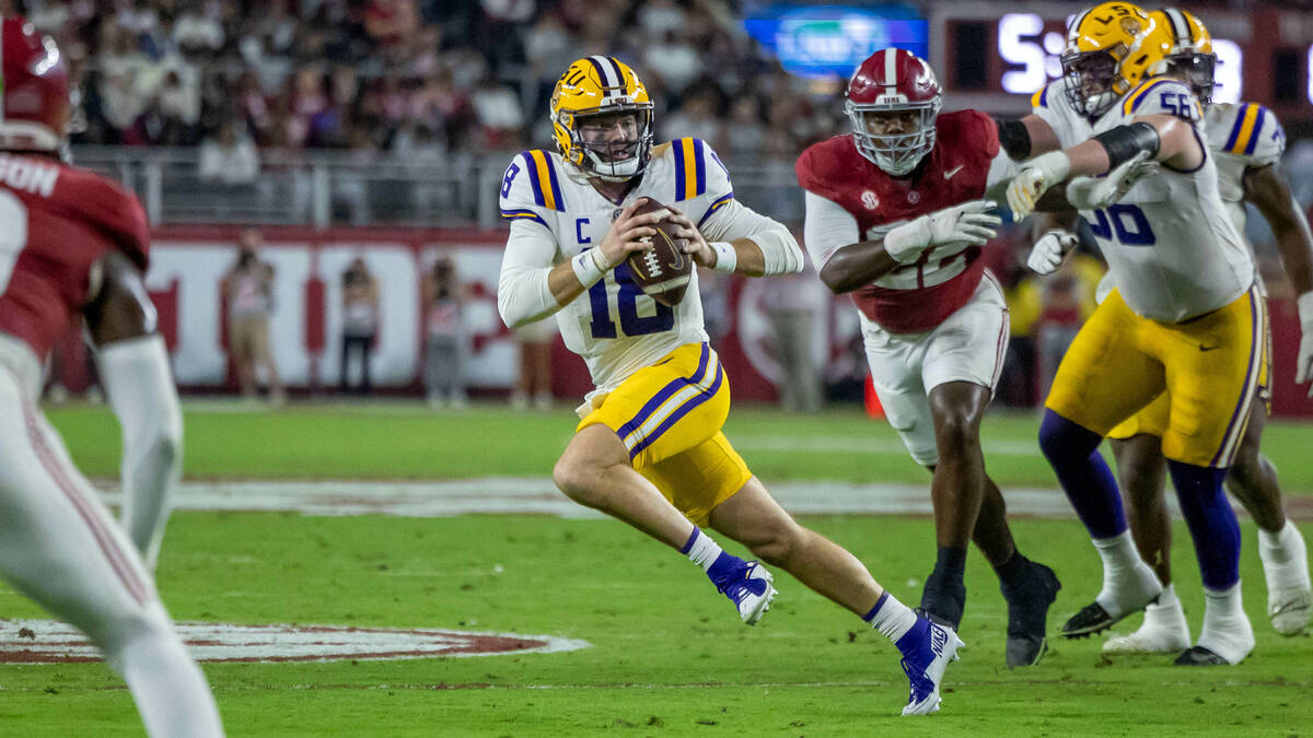 LSU quarterback Garrett Nussmeier (18) runs from pressure from Alabama during the first half of ...