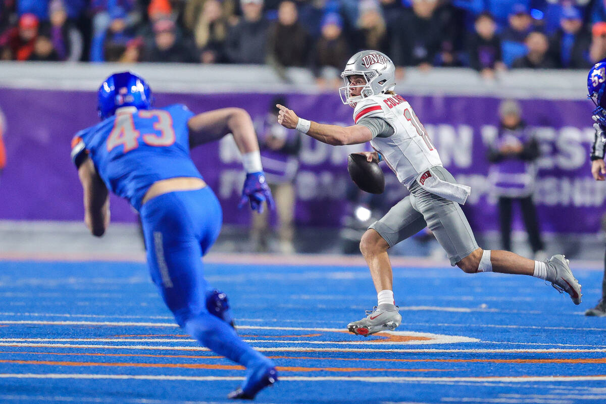 UNLV quarterback Anthony Colandrea (10) directs a wide receiver against Boise State as he scram ...