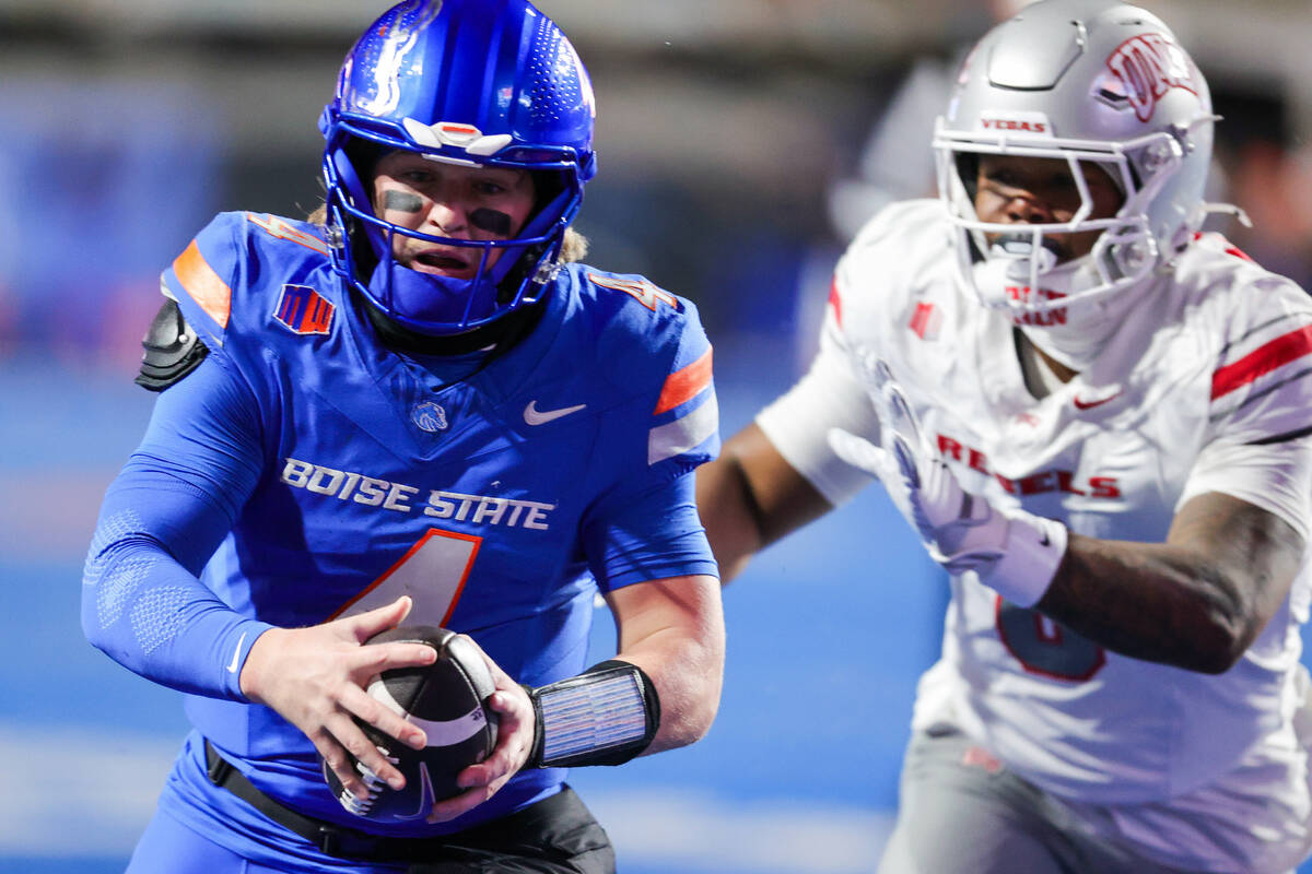 Boise State quarterback Maddux Madsen (4) runs past a UNLV defender for a 10-yard touchdown run ...