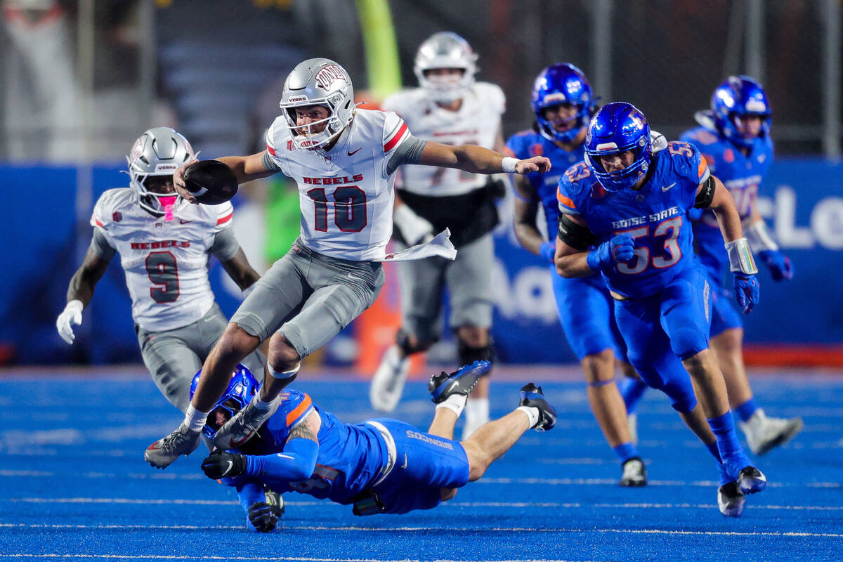 UNLV quarterback Anthony Colandrea (10) is tripped up on a run by Boise State linebacker Boen P ...