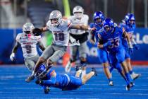 UNLV quarterback Anthony Colandrea (10) is tripped up on a run by Boise State linebacker Boen P ...