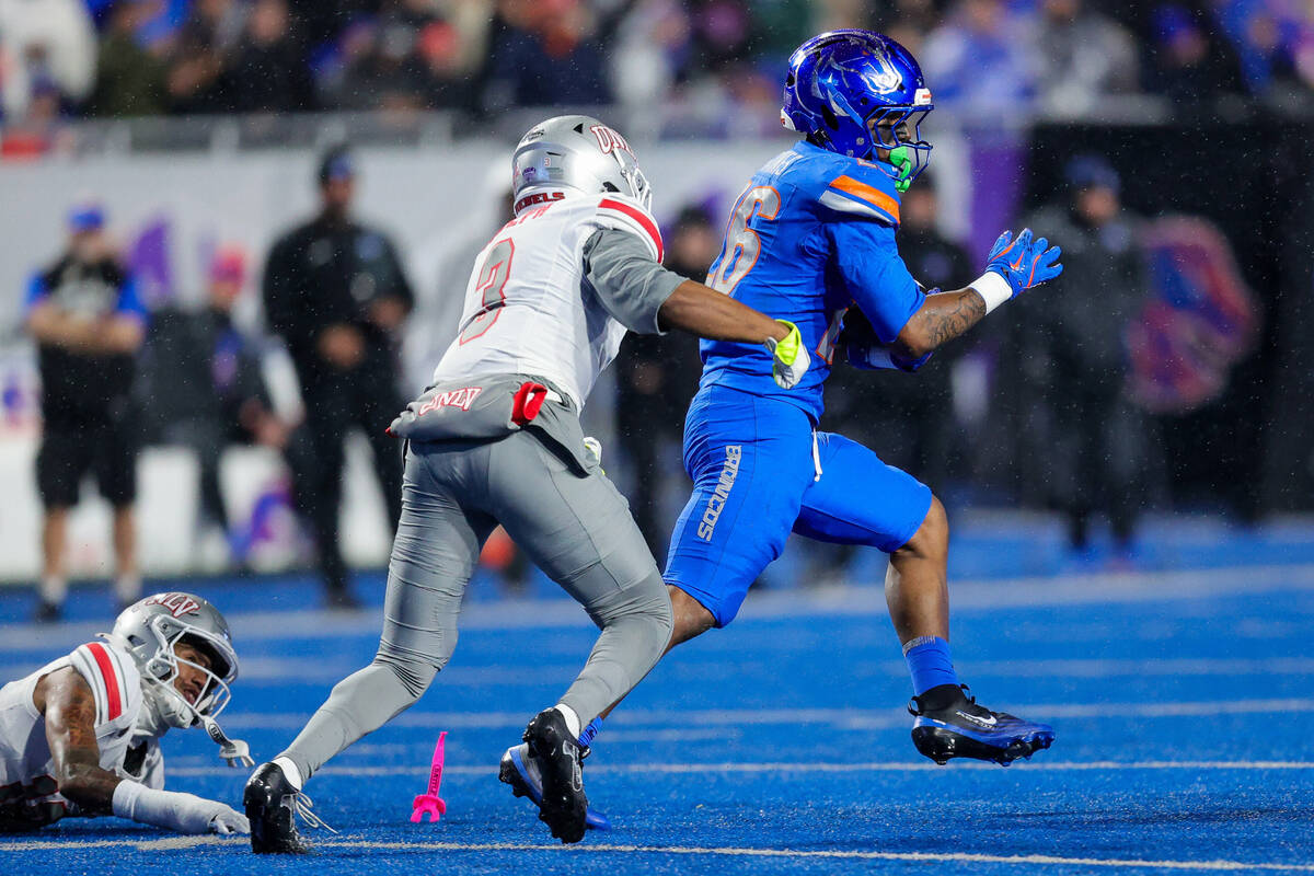 Boise State running back Sire Gaines, right, breaks away from UNLV defensive back Jaheem Joseph ...