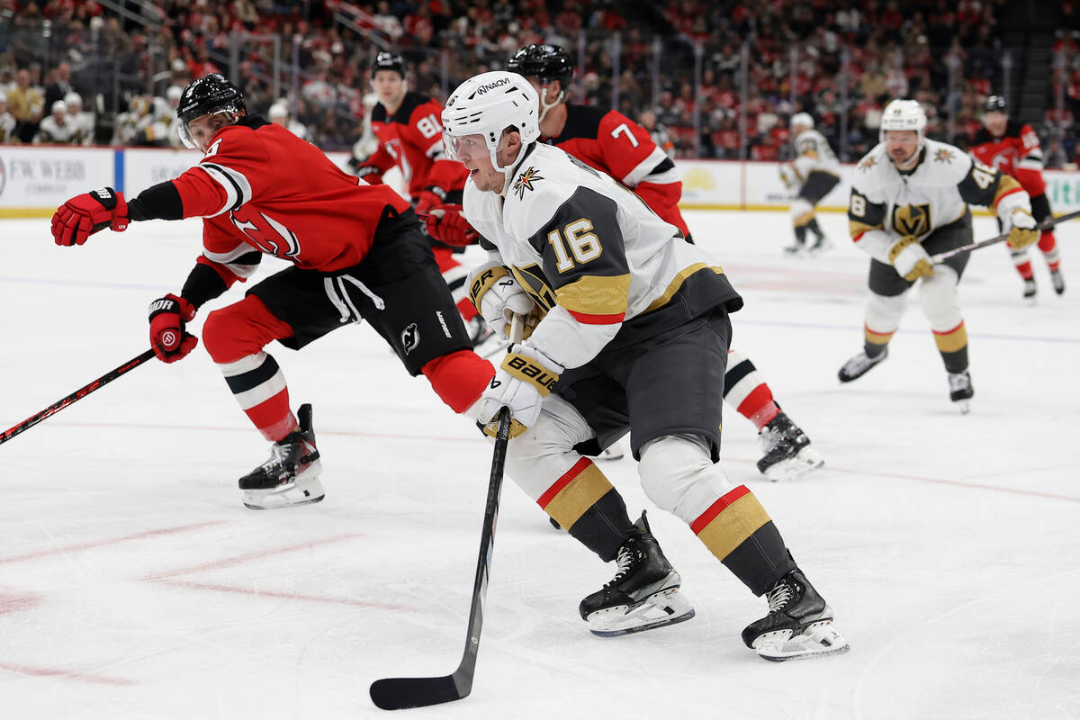 Vegas Golden Knights right wing Pavel Dorofeyev (16) controls the puck past New Jersey Devils d ...