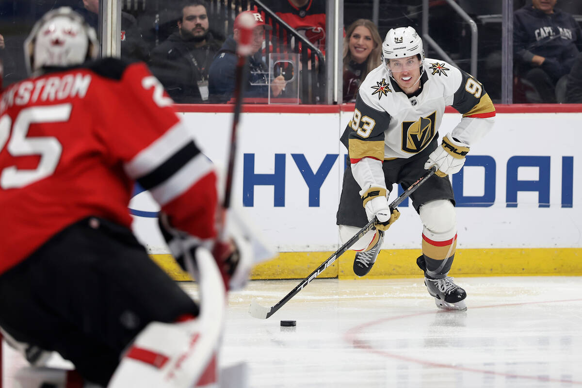 Vegas Golden Knights right wing Mitch Marner (93) looks to shoot on New Jersey Devils goaltende ...