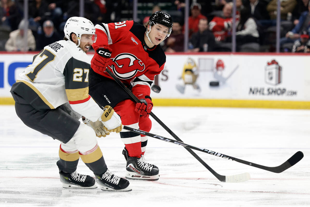 New Jersey Devils right wing Arseny Gritsyuk, right, passes the puck past Vegas Golden Knights ...