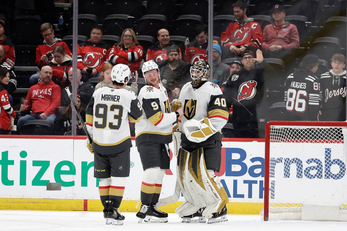 Vegas Golden Knights goaltender Akira Schmid (40) is congratulated by center Jack Eichel (9) an ...