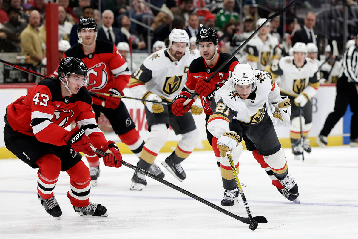 Vegas Golden Knights center Brett Howden (21) looses the puck to New Jersey Devils defenseman L ...