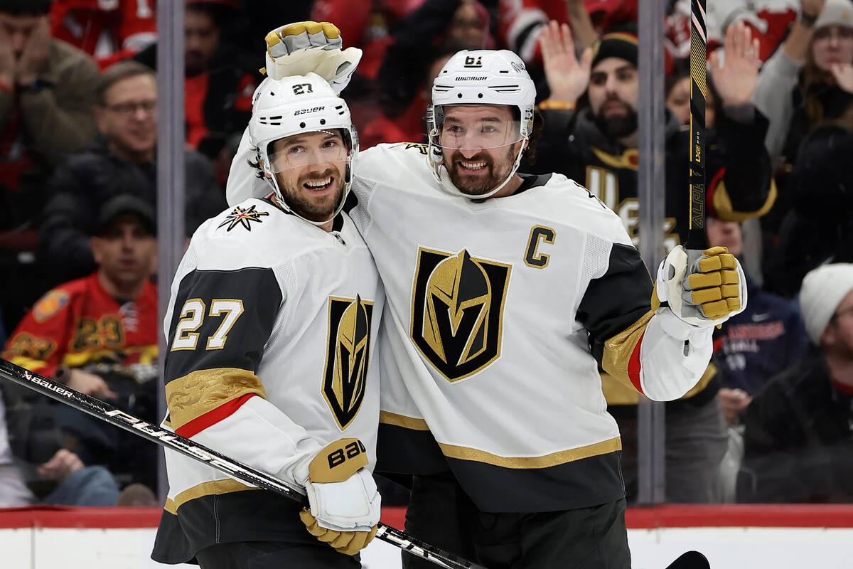 Vegas Golden Knights defenseman Shea Theodore (27) is congratulated after scoring a goal by Mar ...