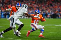 Denver Broncos running back RJ Harvey (12) runs against Las Vegas Raiders safety Jeremy Chinn ( ...
