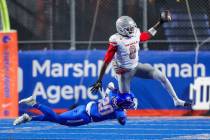 UNLV wide receiver Troy Omeire (0) tries to jump through the tackle attempt of Boise State corn ...