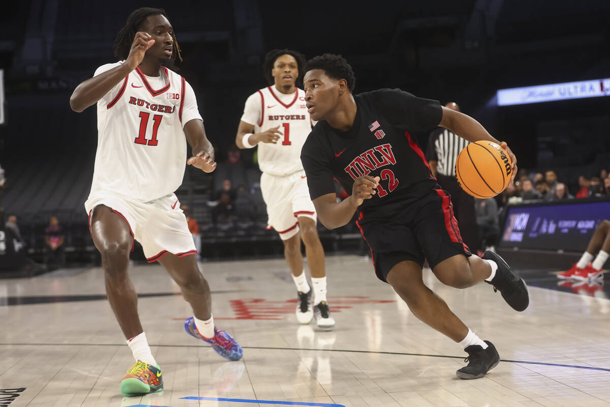 UNLV guard Issac Williamson (12) drives to the basket against Rutgers forward Christopher Nwuli ...