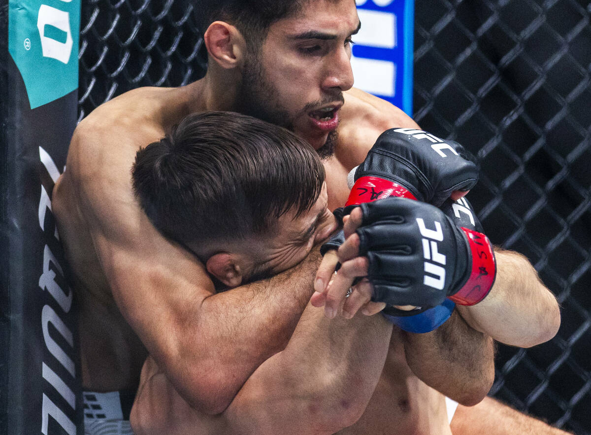 Nazim Sadykhov has his face squeezed by Farés Ziam their lightweight fight in UFC 323 at the T ...