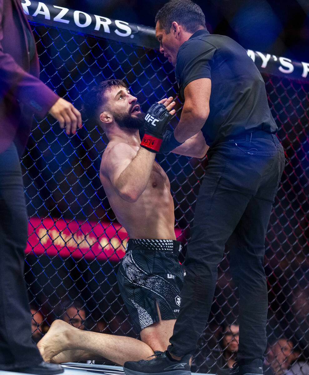 Nazim Sadykhov is down on the canvas and pleads with the referee as Farés Ziam is given th ...