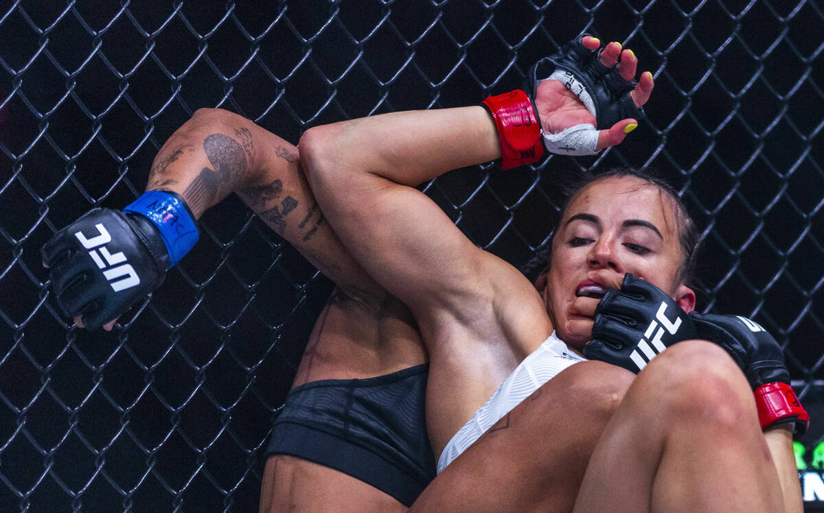 Maycee Barber leans up against the fence and into Karine Silva during their women’s flyw ...