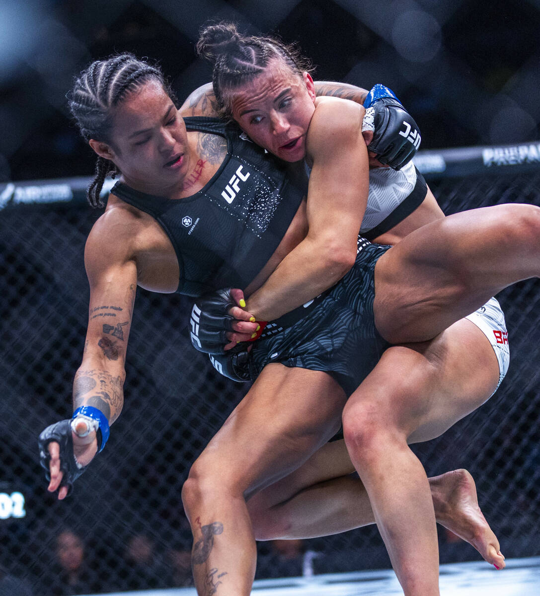 Karine Silva is taken to the canvas by Maycee Barber during their women’s flyweight figh ...