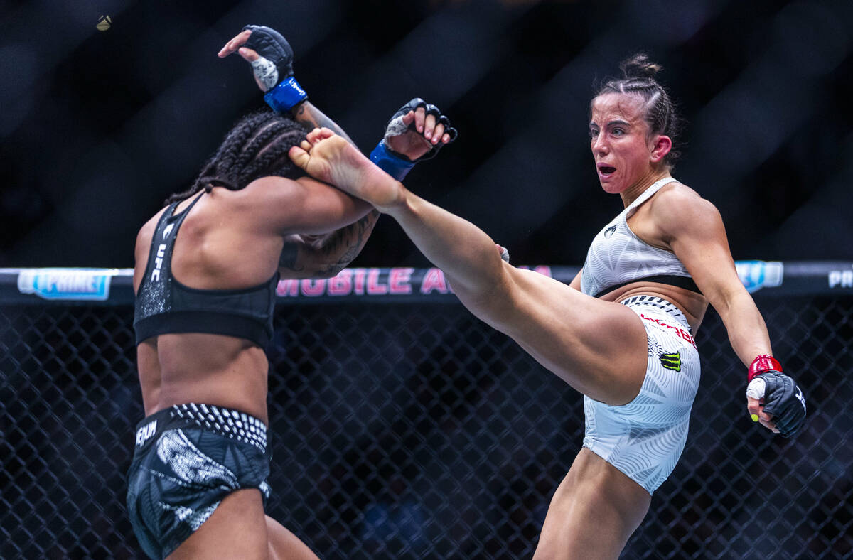 Karine Silva takes a kick tom the head from Maycee Barber during their women’s flyweight ...