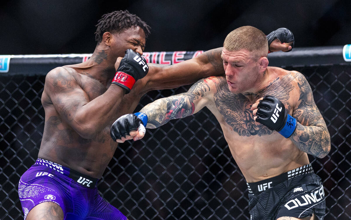 Terrance McKinney and Chris Duncan trade strikes during their lightweight fight in UFC 323 at t ...