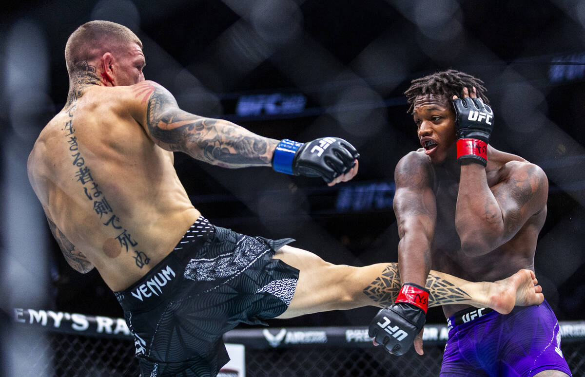 Chris Duncan connects with a kick on the side of Terrance McKinney during their lightweight fig ...