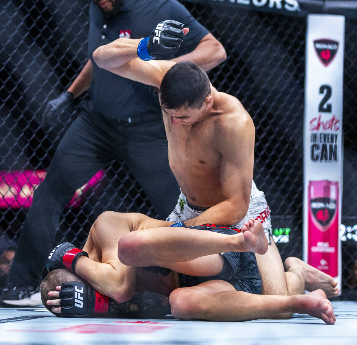 Manuel Torres pounds on Grant Dawson who continues to cover up on the canvas during their light ...