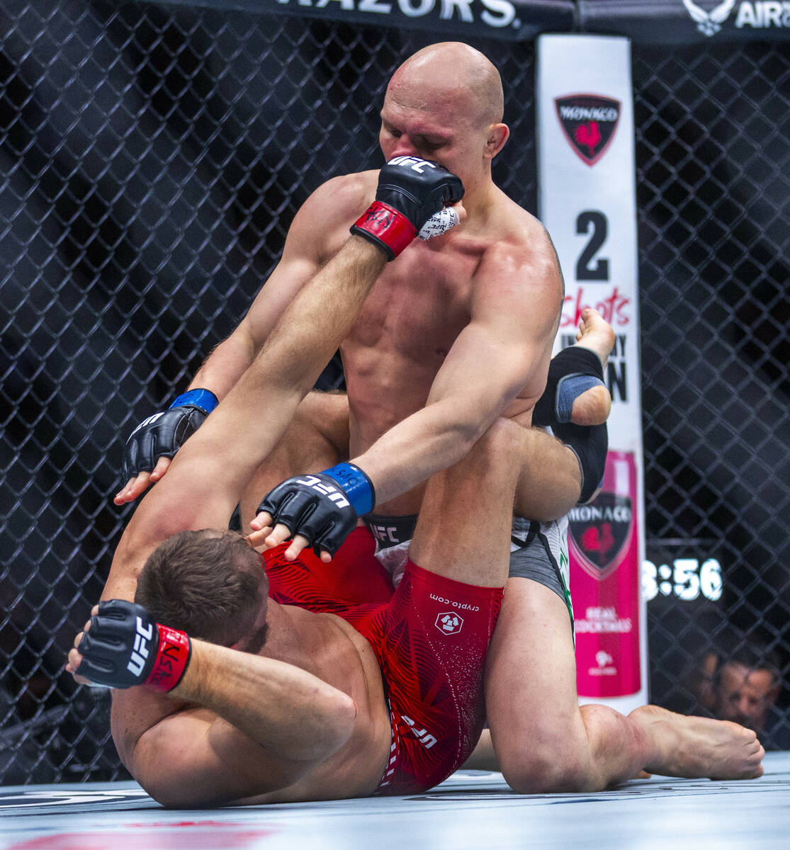 Bogdan Guskov takes a punch as Jan Blachowicz is down during their light heavyweight fight in U ...