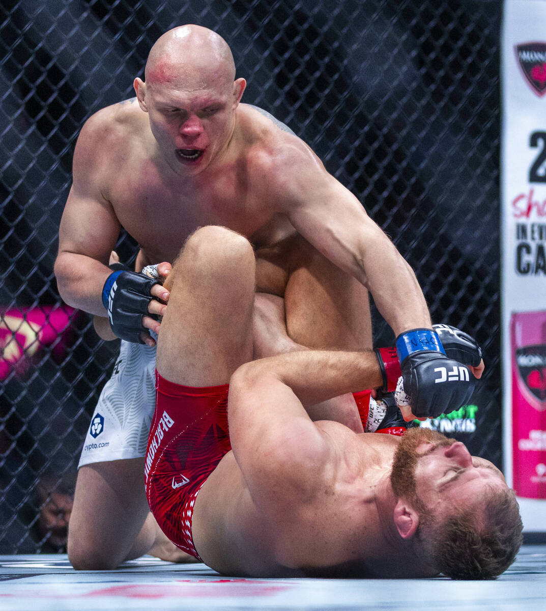 Bogdan Guskov sends a punch down on Jan Blachowicz during their light heavyweight fight in UFC ...
