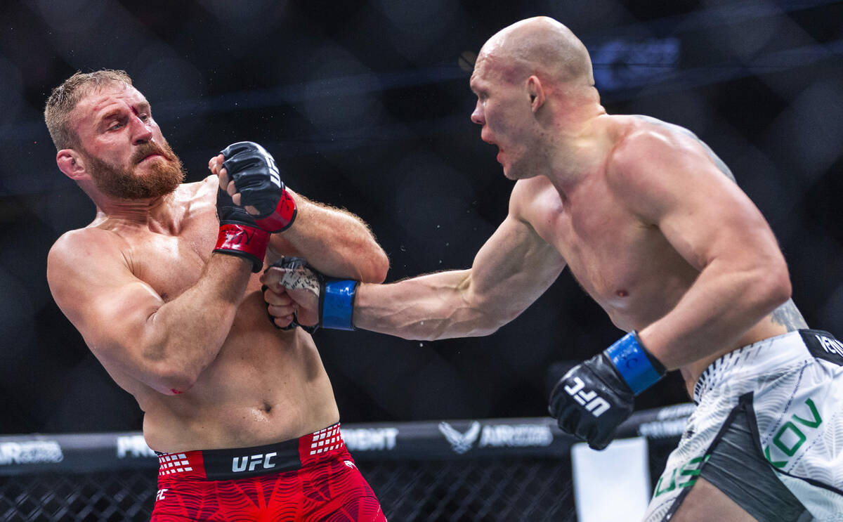 Jan Blachowicz takes a punch to the chest from Bogdan Guskov during their light heavyweight fig ...