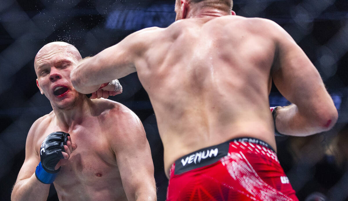 Bogdan Guskov takes a punch from Jan Blachowicz during their light heavyweight fight in UFC 323 ...