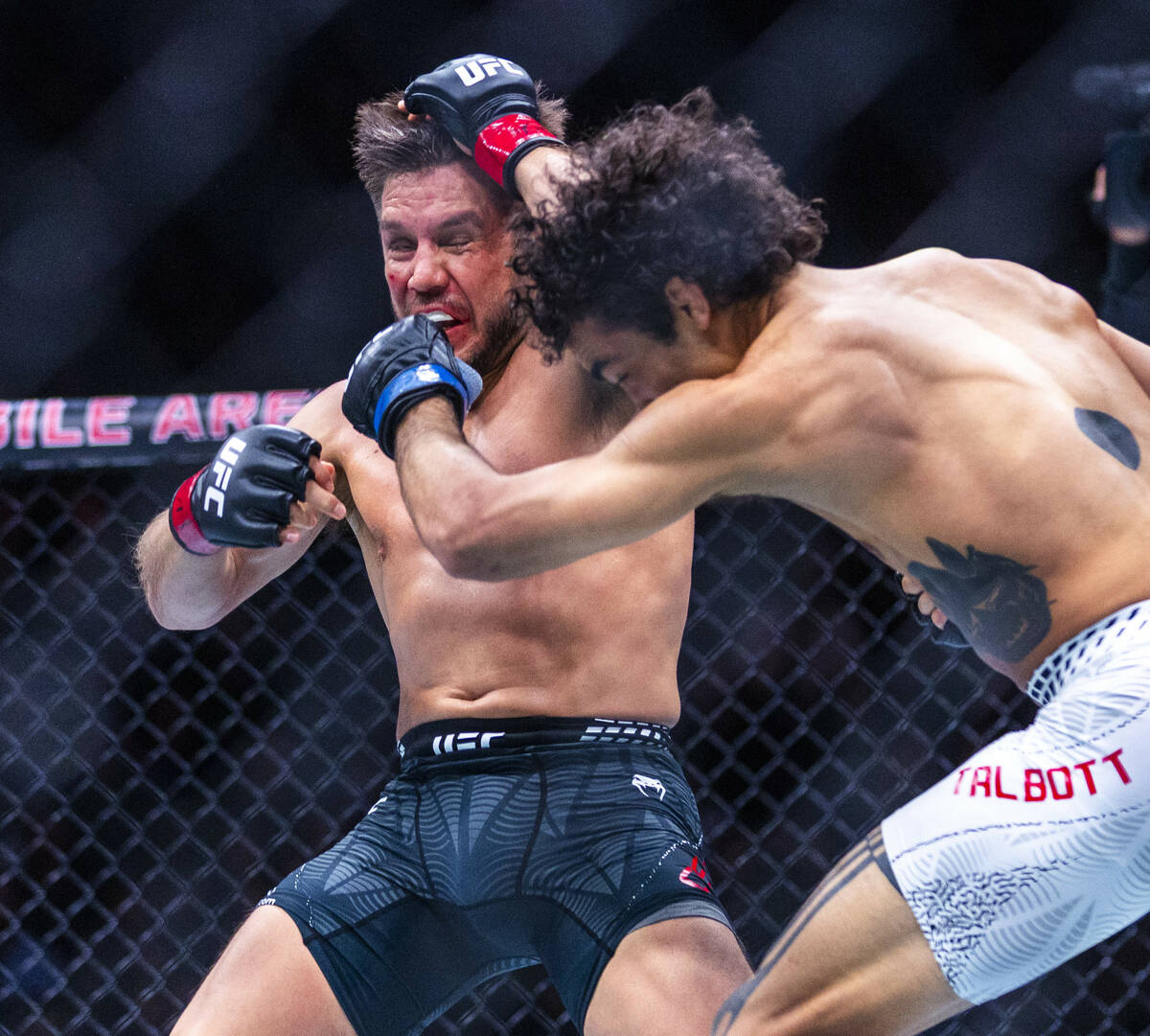 Henry Cejudo takes a shot to the face from Payton Talbott during their bantamweight fight in UF ...