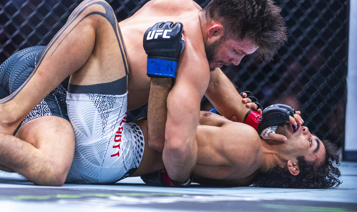 Henry Cejudo drives a palm into the chin of Payton Talbott during their bantamweight fight in U ...