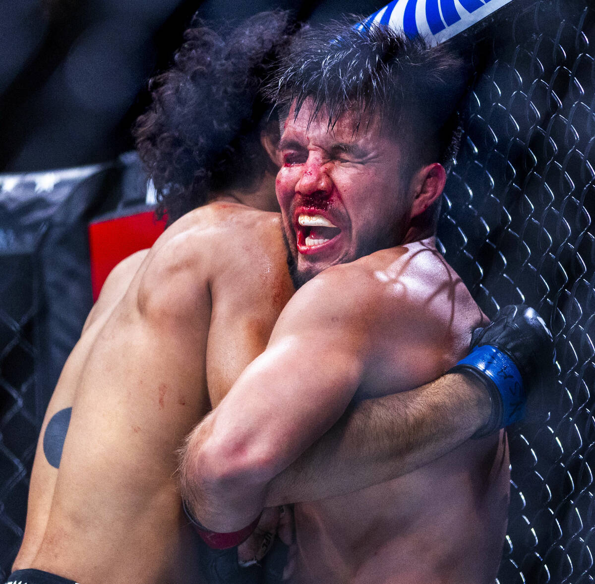 Henry Cejudo is in pain against the fence by Payton Talbott during their bantamweight fight in ...