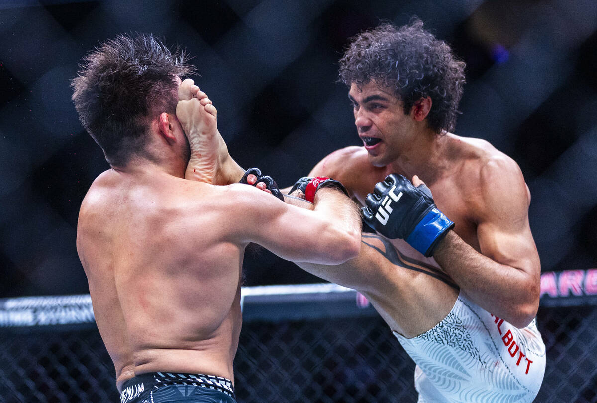 Henry Cejudo takes a kick to the face from Payton Talbott during their bantamweight fight in UF ...