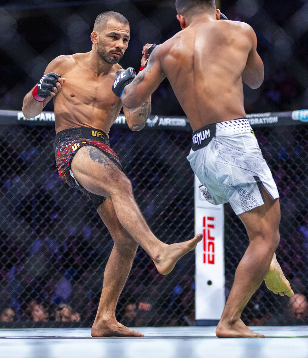 Alexandre Pantoja sends a kick at Joshua Van during their flyweight title fight in UFC 323 at t ...