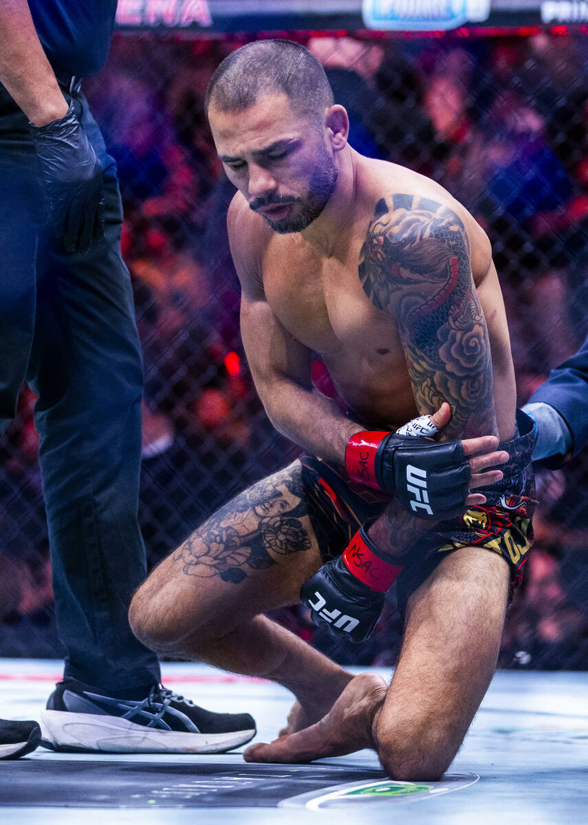 Alexandre Pantoja is down with an arm injury losing to Joshua Van during their flyweight title ...