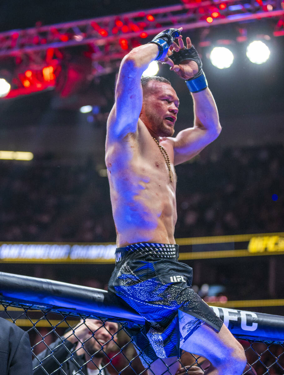 Petr Yan sits atop the octagon to recognize his fans after battling Merab Dvalishvili during th ...