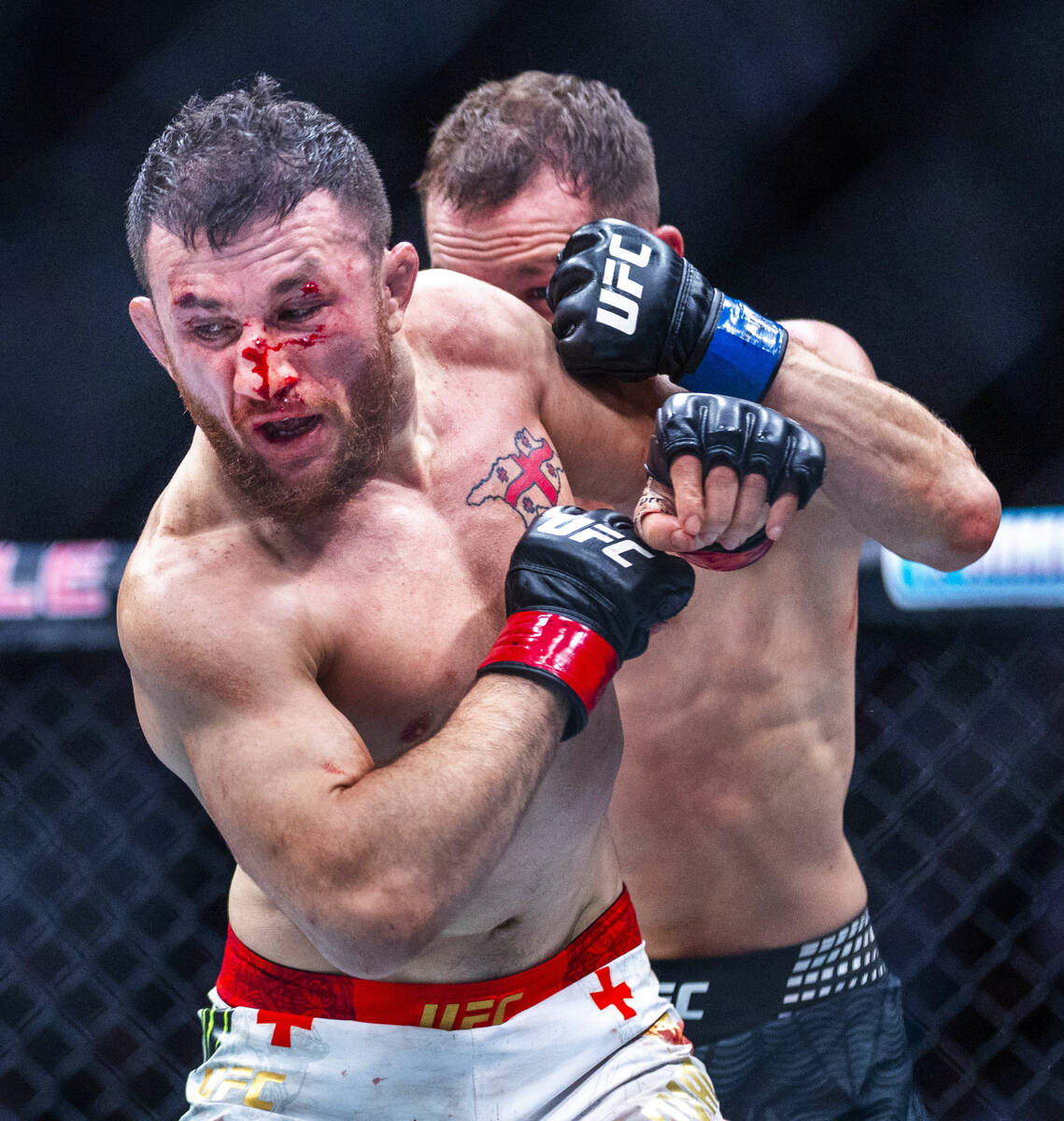 Merab Dvalishvili turns away from Petr Yan who pursues him across the octagon during their bant ...