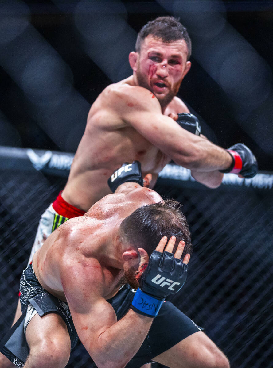 Petr Yan evades a strike from Merab Dvalishvili during their bantamweight title fight in UFC 32 ...