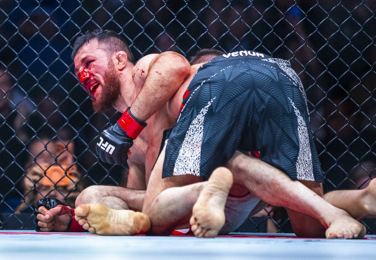 Merab Dvalishvili smiles at the nd of his battle with Petr Yan during their bantamweight title ...