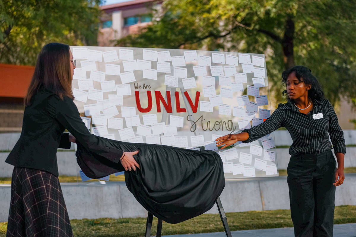 Members of UNLV's student government unveil an art piece during a memorial event commemorating ...