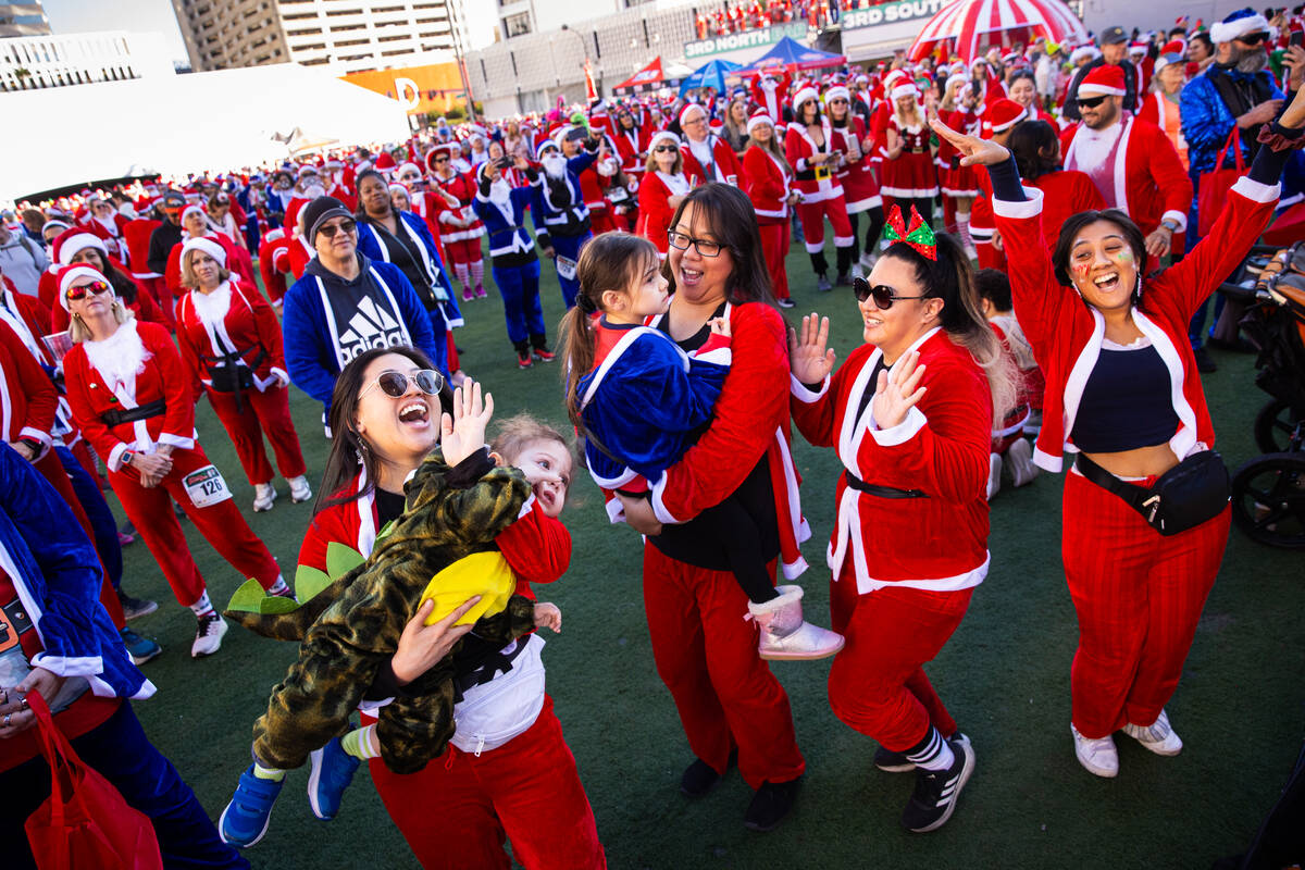 Attendees sing and dance as the cast of “Spice Wannabe” performs before the start ...